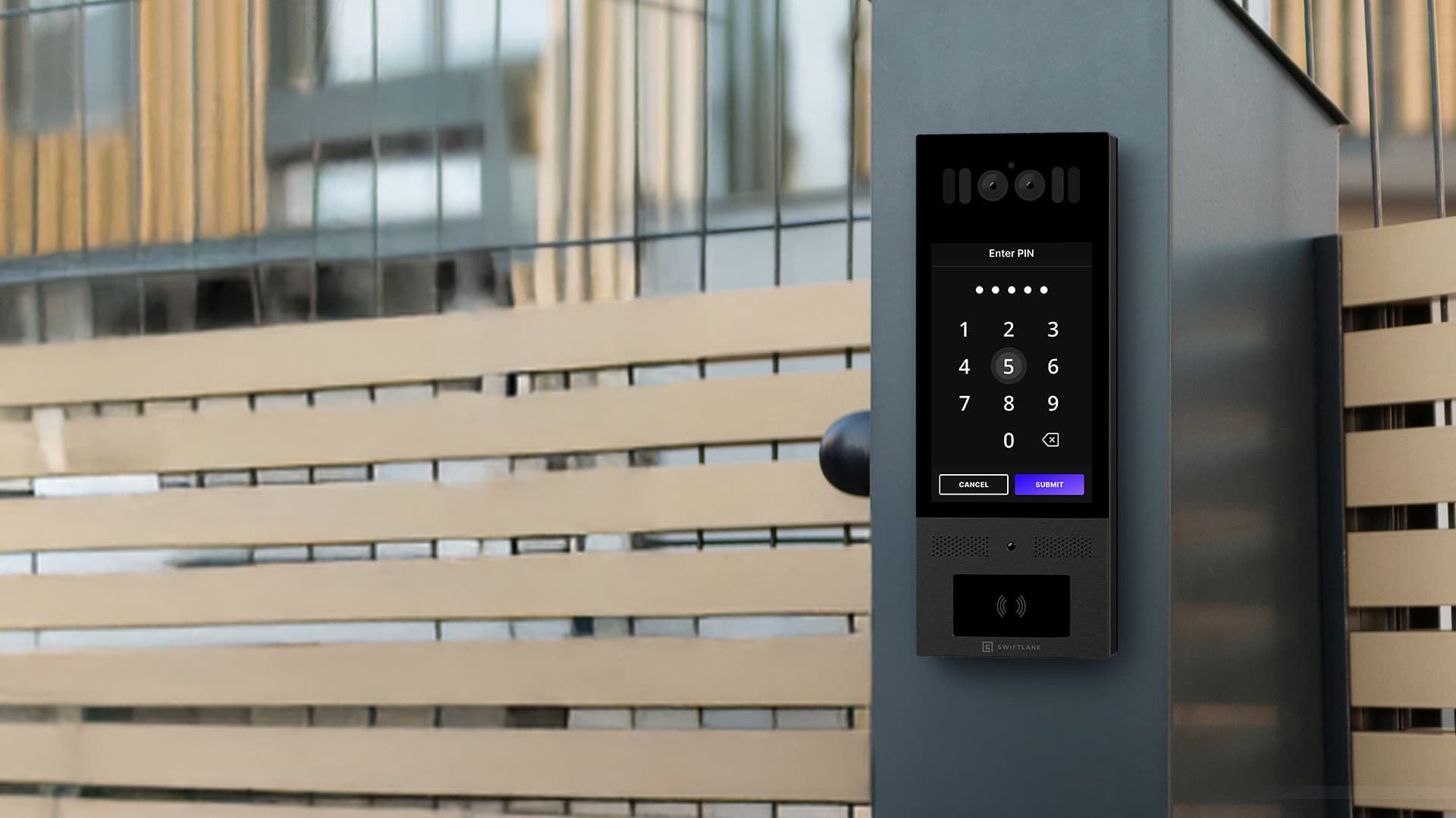 Modern black digital intercom with a touchscreen keypad mounted on a grey gate pillar.